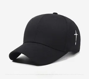 Detailed side view of black cotton baseball cap with white cross embroidery detail