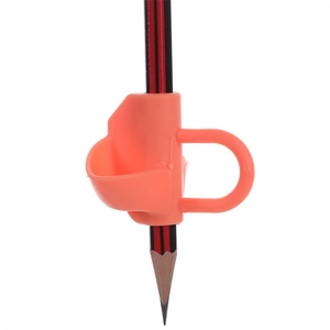 Detailed close-up of an orange silicone pencil gripper for correct writing posture