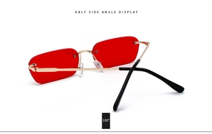 Detail view of red rimless rectangle sunglasses with gold metal temples and 180 degree hinge