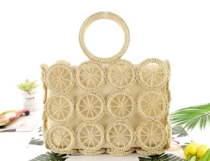Detail of hollow woven paper rope beach bag with circular patterns and round handles