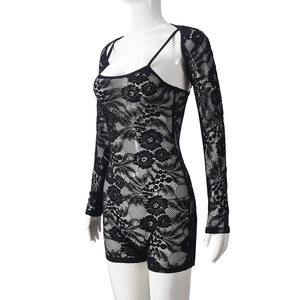 Detail of black lace jumpsuit set with long sleeve cutout jacket on a mannequin