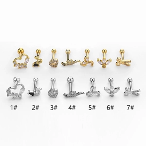 Macro view of assorted heart and swan stainless steel ear studs with zircon stones