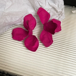 Detail of matte magenta 3D flower earrings with painted metal finish for a bold look