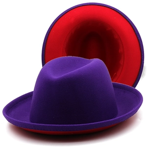 Detail view of two-tone wool fedora hat with purple exterior and contrast red lining