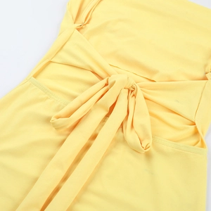 Detailed close-up of the elegant knot design on a slim lemon yellow summer dress