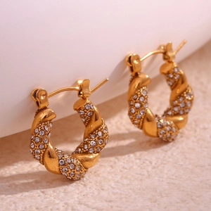Gold twisted hoop earrings with pavé set cubic zirconia and elegant pearl accents