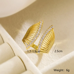Detail of gold-plated geometric ring with double row of zircons in velvet jewelry box