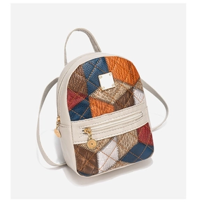 Detail of small backpack with geometric multi-color leather patchwork and quilted texture