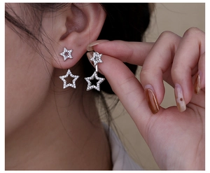 Detail of s925 silver star earrings with zircons shown on model for elegant styling