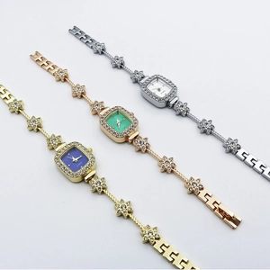 Elegant square quartz bracelet watch set with crystals and floral chain links in gold and silver