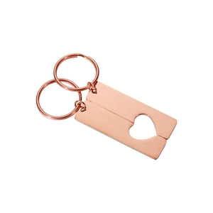 Macro view of mirror polished rose gold heart puzzle rectangle couple keychains