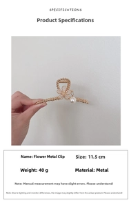 Close-up of golden flower metal hair clip with pearls and rhinestones measuring 11.5cm