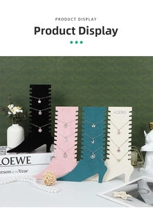 Detail view of colorful high-heel velvet jewelry stands showing multiple necklace slots