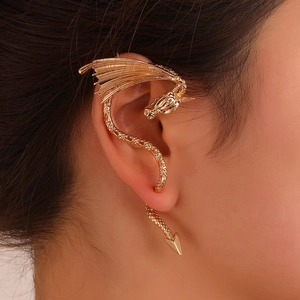 Exaggerated golden dragon ear cuff featuring intricate wings and scales texture