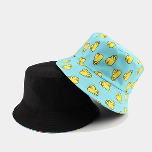 Reversible bucket hats in black and light blue with yellow duck pattern for sun protection