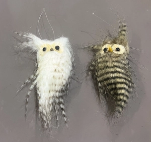 Detailed view of handmade owl ornaments with realistic fur textures and hanging loops