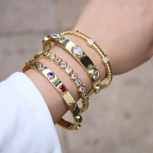 Gold open bangles set with white zircons and multi-colored gemstones for women