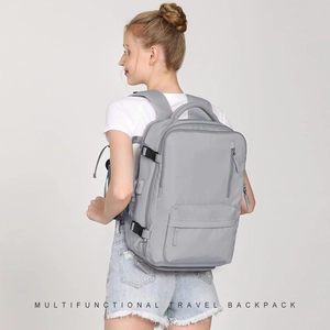 Detailed back view of a grey multifunctional travel backpack with adjustable side straps