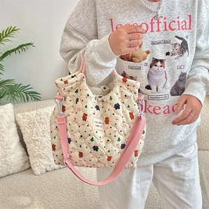 Quilted beige canvas crossbody bag featuring cute cartoon bear prints and a pink strap