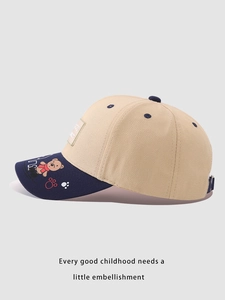 Detail of baby baseball cap with bear embroidery and contrast navy blue brim
