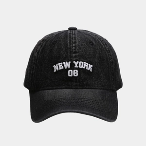 Detailed close-up of white NEW YORK 08 embroidery on washed dark grey denim baseball cap