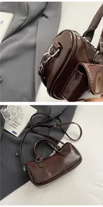 Detail of dark brown patent leather saddle bag with silver hardware and shoulder strap