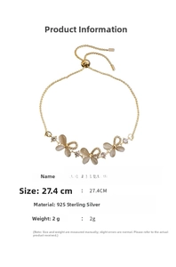 Detail of adjustable golden butterfly bracelet with cat-eye stones and zircons