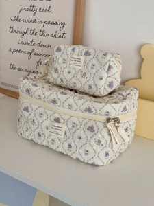 Detailed view of quilted cotton makeup bags with purple floral and rabbit pattern