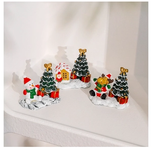 Miniature resin Christmas figurine set featuring a snowman, reindeer, house, and tree