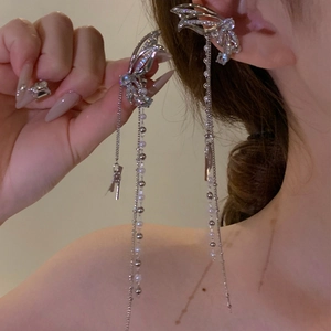 Close-up of silver butterfly tassel ear cuff with pearls and crystals on ear