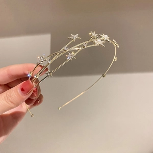Detail of gold star headband featuring sparkling rhinestones and elegant pearls