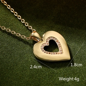 Macro detail of 18K gold plated heart pendant showing 2.4cm by 1.8cm size and 4g weight