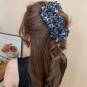 Large leopard print chiffon hair clip on long wavy hair with vintage French background