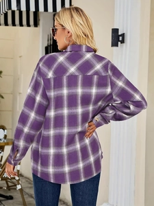 Detail of classic purple plaid long sleeve shirt showing fabric texture and back fit