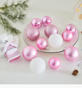 Detailed view of assorted pink and white Christmas ornaments with glitter and matte textures