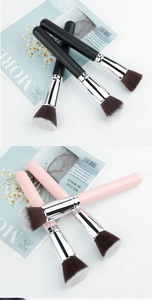Detail view of round synthetic fiber makeup brushes with matte handles and silver ferrules