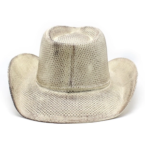Detail of woven straw cowboy hat with vintage brown finish and classic top indentation