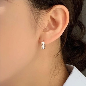 Minimalist 925 sterling silver ball earrings shown on female model from a side profile