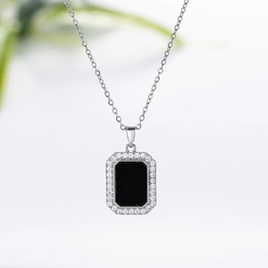Detail of silver titanium necklace with a black rectangular pendant and pave zircons