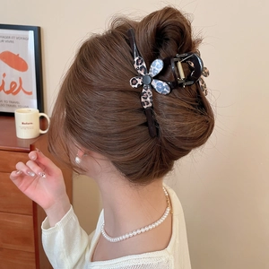 Detail of leopard print flower hair claw clip styling a Korean updo hair on a woman
