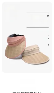 Close-up of UPF50+ pink and beige sun visors with mesh top and metal G logo buckle