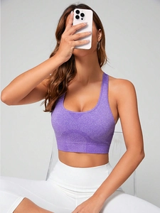 Close-up of purple high-stretch seamless sports bra with wide straps and ribbed hem