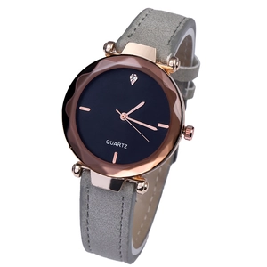 Detailed macro view of the rose gold wave bezel and black minimalist quartz watch dial