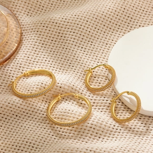 Macro detail of gold plated hoop earrings with double rows of sparkling cubic zirconia
