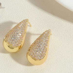 Detailed close-up of water drop earrings with gold finish and inlaid zircon stones