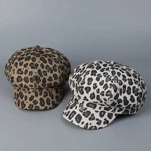 Detail view of stylish leopard print baker boy hats in brown and light grey colors