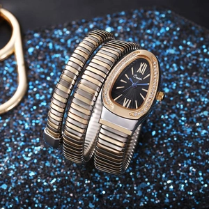 Macro shot of silver-gold snake watch with diamond-set case and sunburst dial