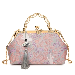 Elegant grey shell bag with pink jacquard floral pattern and golden cat handle