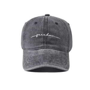 Close-up of freedom script embroidery on vintage washed cotton black baseball cap