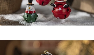 Detailed view of metal Christmas bells featuring snowman and Santa on faux snow
